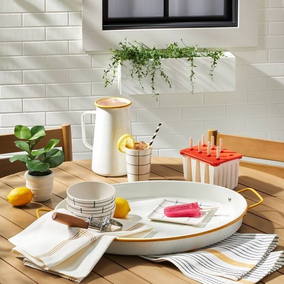 weekend meanderings table set with a white and yellow enamelware tray pitcher 4 bowls and an ice cream scoop