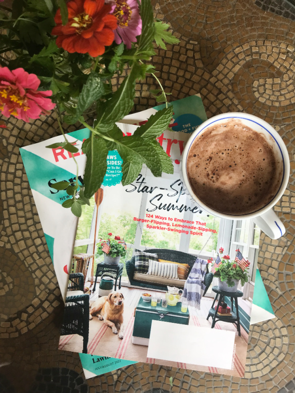 weekend meanderings flatlay with better homes and gardens real simple and hot chocolate and flowers