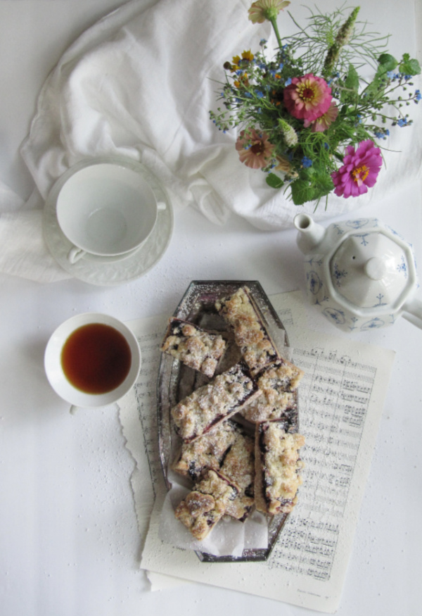 flatlay browned butter roasted cherry shortbread bars with flowers and tea-2