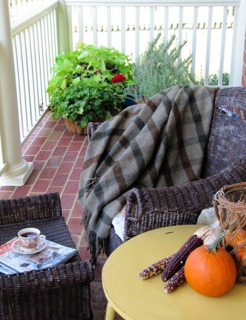 Fall porch with plaid throw and pumpkins