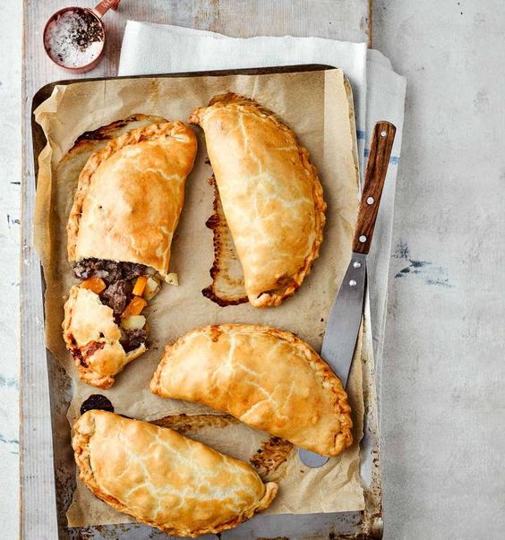 sheet pan lined with parchment and three pasties