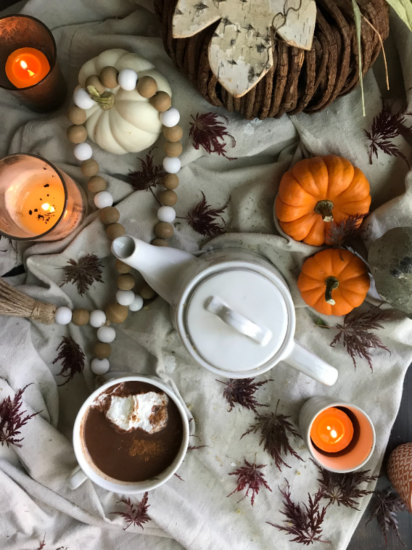 fall flatlay candles pumpkins hot chocolate