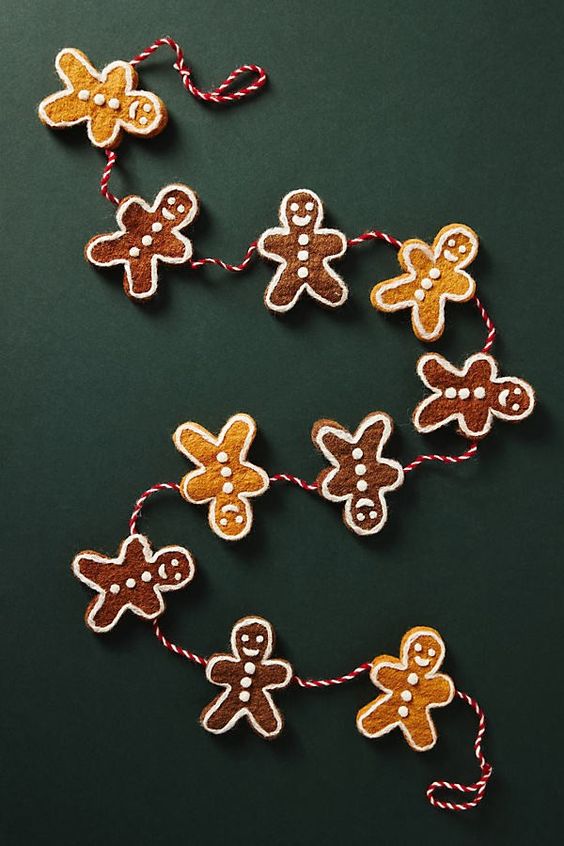 gingerbread men garland on a dark green background. 