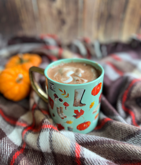 Fall mug pumpkins on a tartan throw