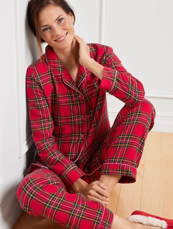 woman sitting cross legged on the floor wearing plaid pajamas