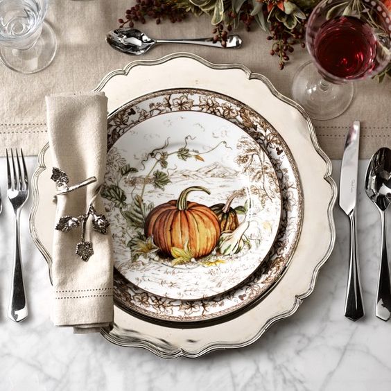 thanksgiving table place setting with a pumpkin