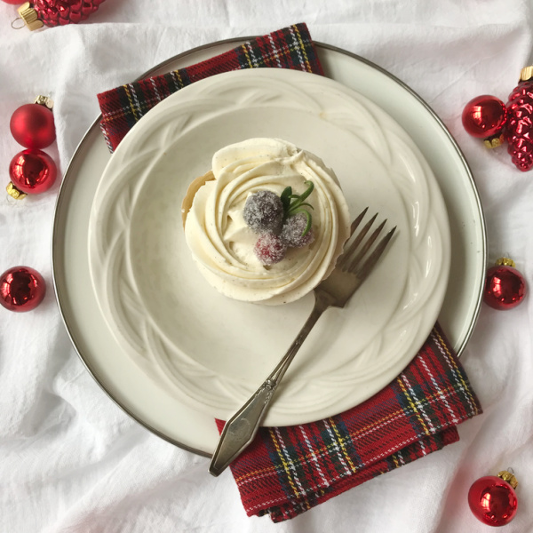 cupcakes with buttercream frosting and candied cranberries