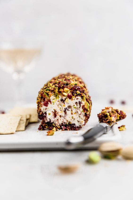 cheese log with cranberries bacon pistachios and honey.