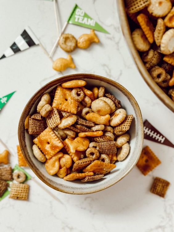 Chex mix in a white bowl.