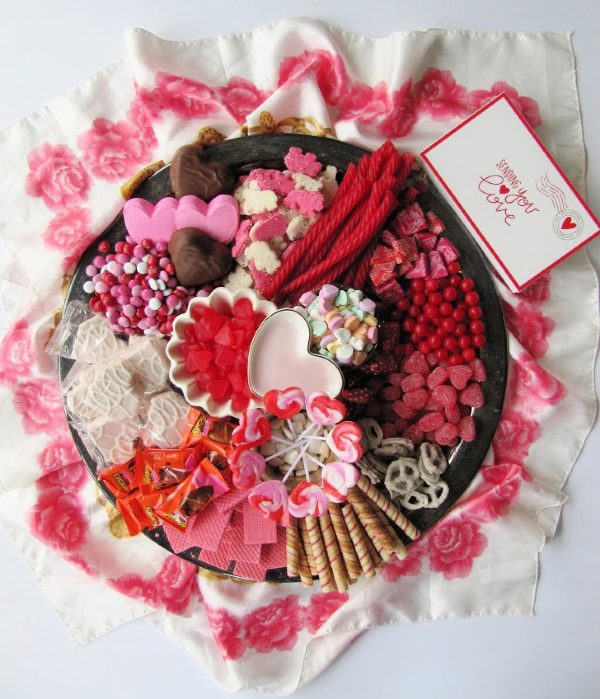 Large round tray filled with cookies and candy in shades of red and pink. 10 Easy Valentine's Day Desserts