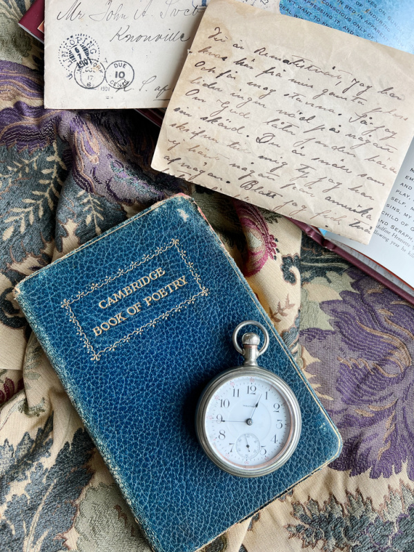 flatlay with book of poetry and vintage letters, intentional living in midlife.