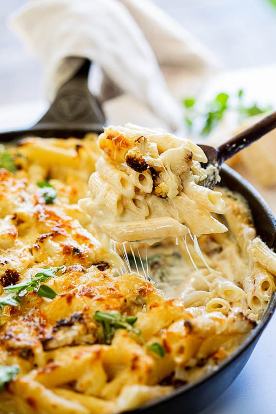 Creamy cauliflower pasta bake in a cast iron skillet.