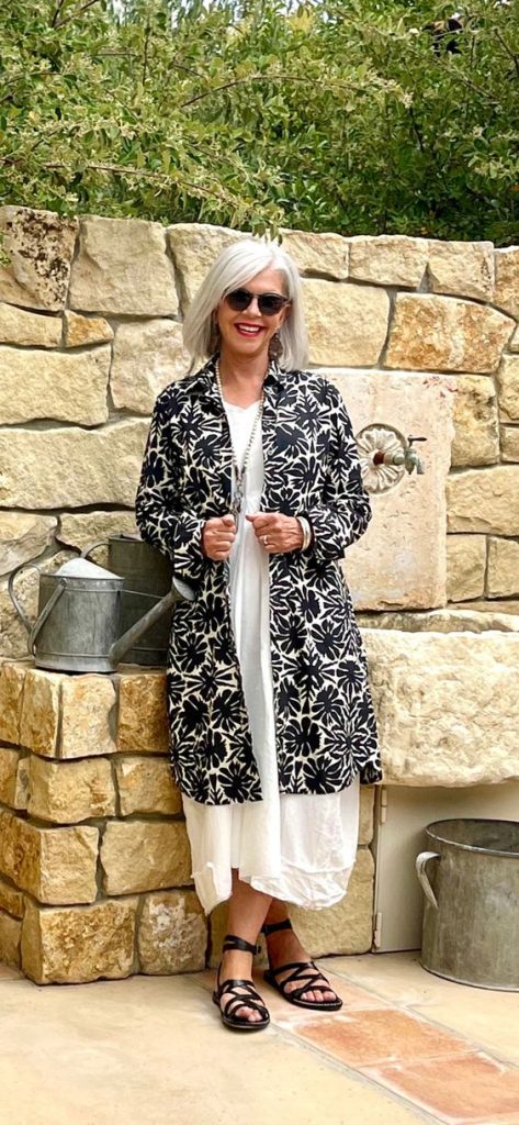 Cindy Hattersley in a white outfit with a black and white coat. 