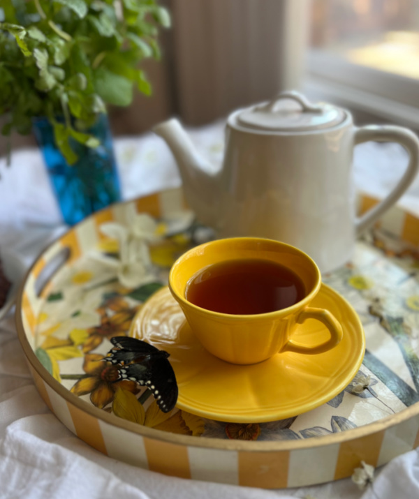 spring tea time with yellow cups and a white teapot.