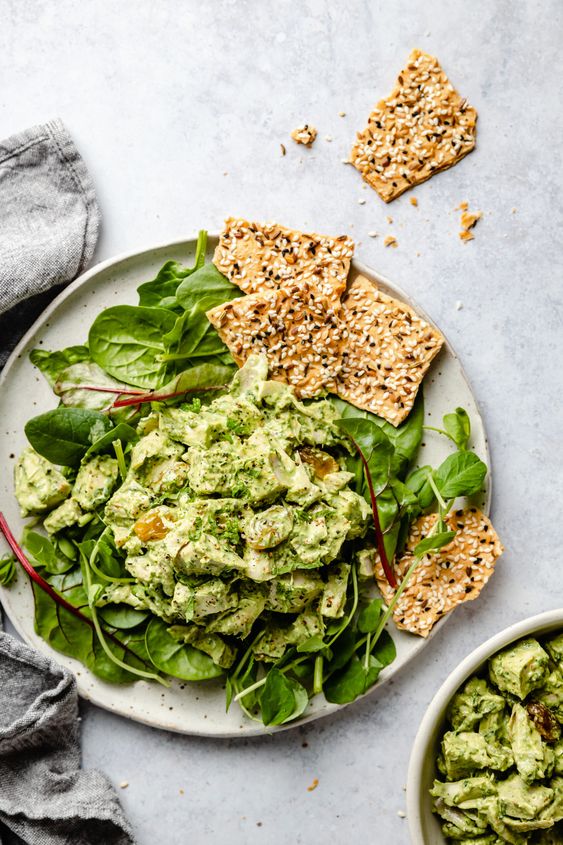 Herby chicken salad on a bed of lettuce with seeded crackers. 