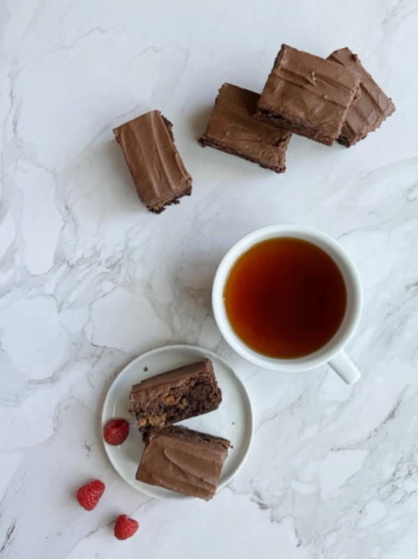 dulce de leche brownies and a cup of tea in a white cup.