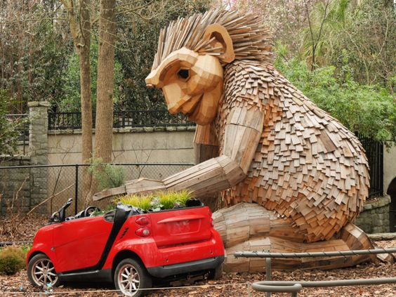 Thomas Dambo’s Rosa Solfinger Planting in Car sculpture made from recycled wood.