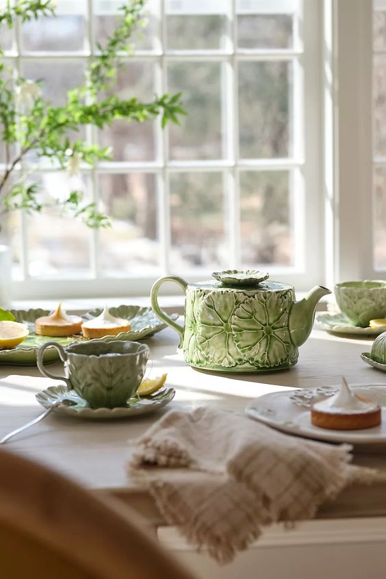 Mothers day gift ideas Lilypad Teapot and cups sitting in front of a window. 