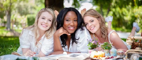 An image of three women smiling at the camera. 