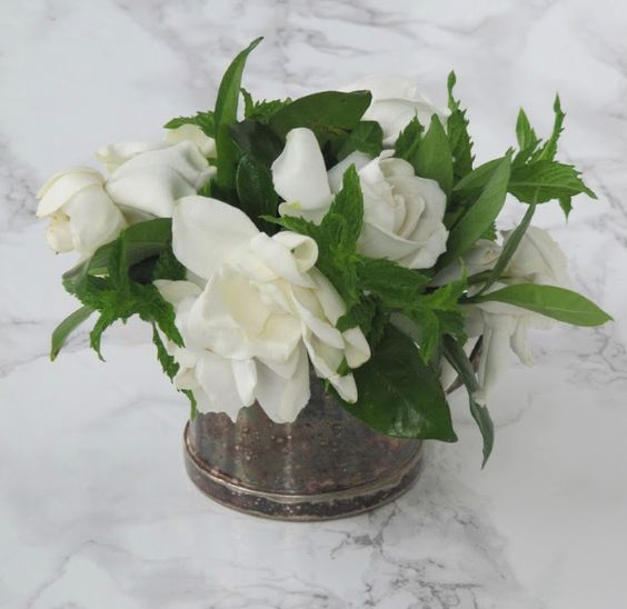 Flowers in vintage silver container. 