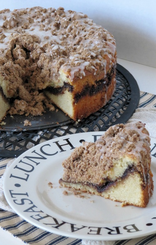 triple-cinnamon coffee cake, with one piece sliced on a plate. 
