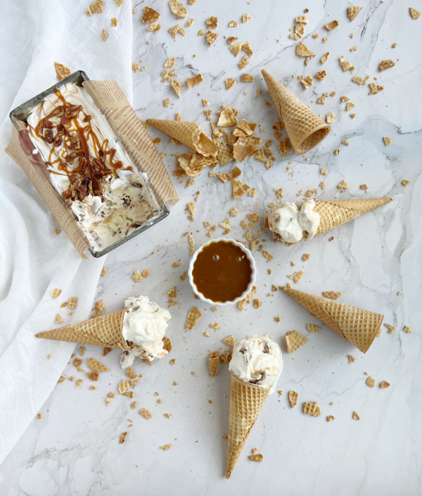 Salted Caramel Candied Pecan "No Churn" Ice Cream with sugar cones and a bowl of caramel. 