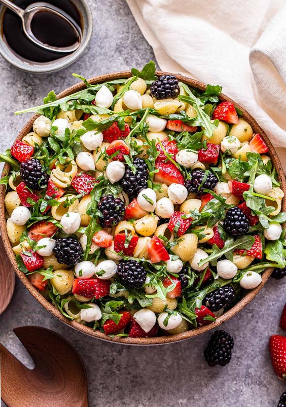 summer berry pasta salad in a large bowl. 
