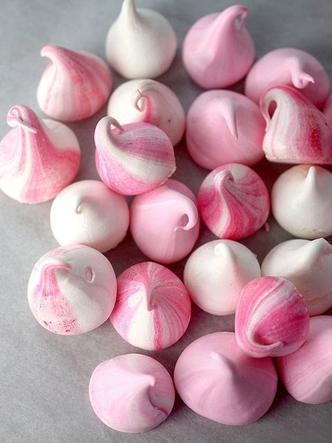 Pink and white meringue kisses.