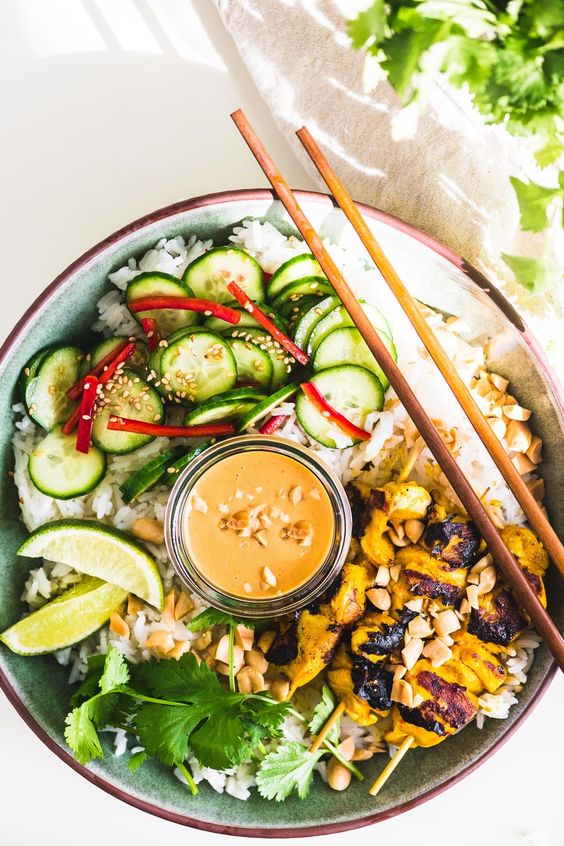 Chicken satay bowl with peanut sauce.