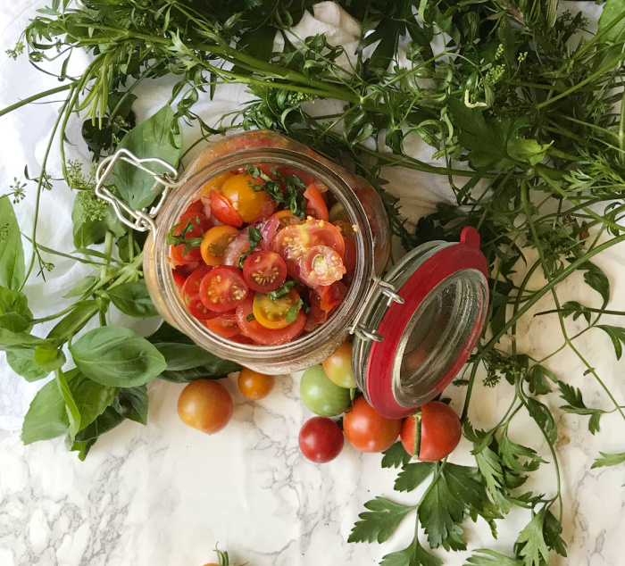 marinated cherry tomatoes in a glass jar. 