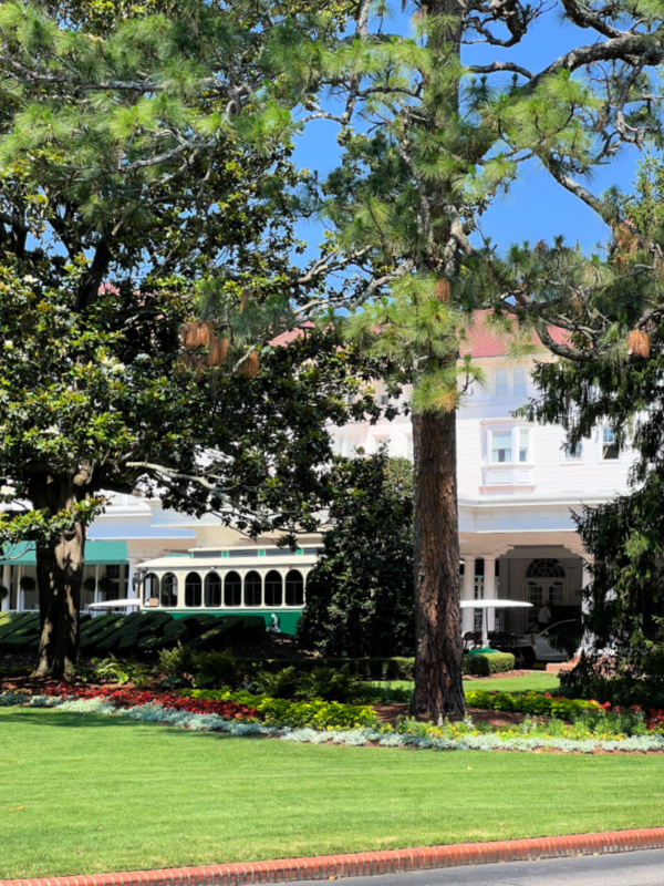 The front of the Carolina hotel and a green trolley.