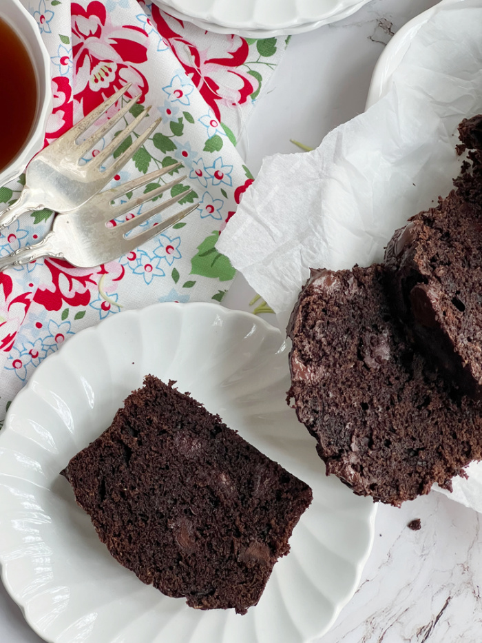 chocolate zucchini bread sliced on a white plate.