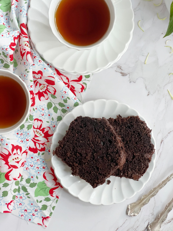 double chocolate zucchini bread sliced with 2 cups of tea.