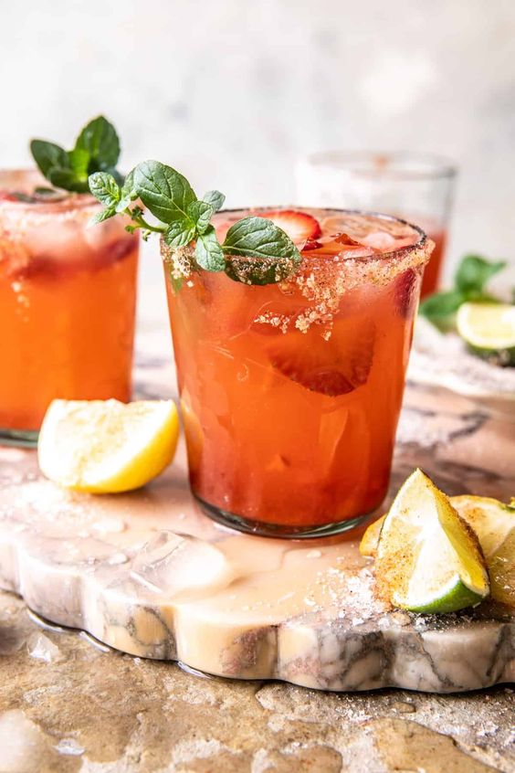 2 old fashioned glasses with aperol spritz margaritas and lines. 