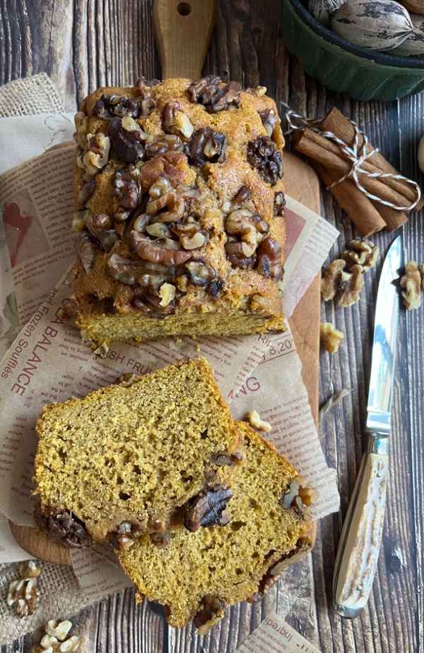 ourdough discard pumpkin bread with walnuts and an antler handles knife. 