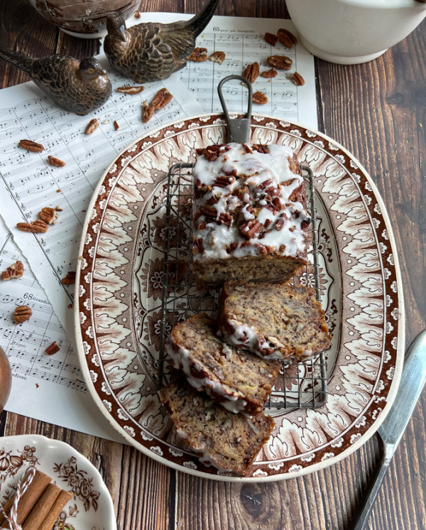 chai zucchini loaf cake sliced on brown transfer ware.
