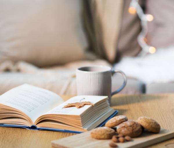 cup of tea open book and cookies.