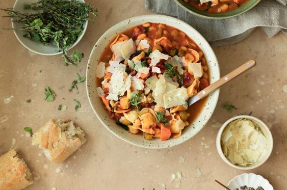 Tortellini Soup in a white bowl. 