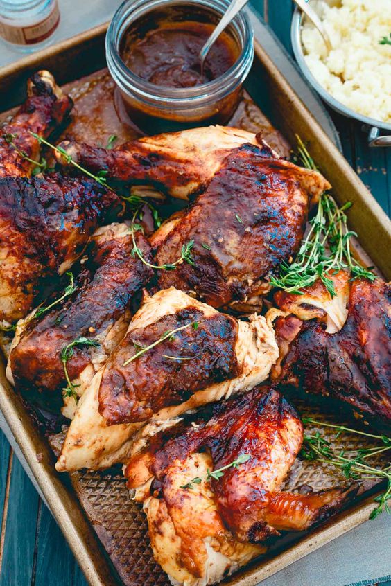 apple butter roasted chicken on a pan with parsley. 