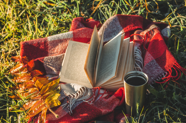 fall book coffee throw on the grass.