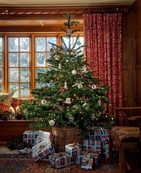 English Country Cottage Christmas decor with tartan plaid, fairy lights, holly, Christmas crackers, orange pomanders, garland and more.