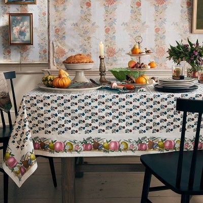 A floral tablecloth, ceramic platters, and napkins, then layer in the salad plate set, a pumpkin-shaped tureen, and even a rooster gravy boat. 