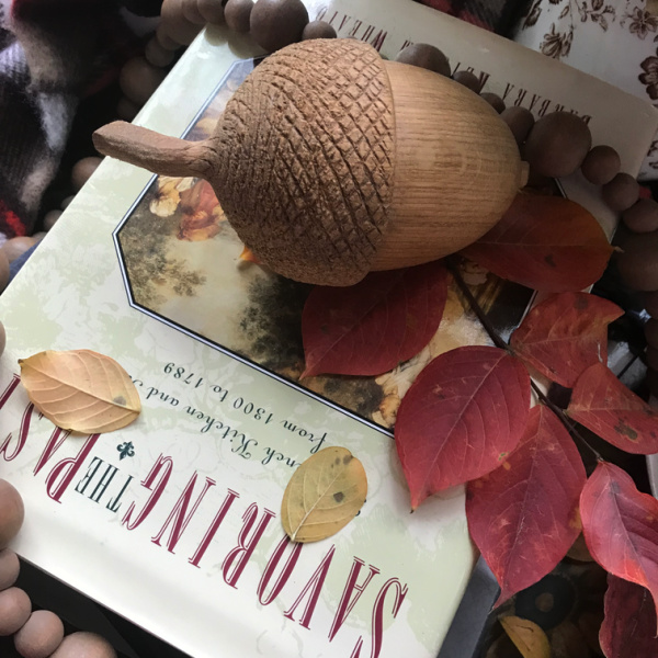 Friday Favorites Flatlay Savoring the past cookbook carved acorn and leaves