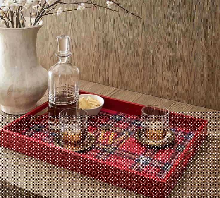 red plaid tray with a crystal decanter and 2 glasses.