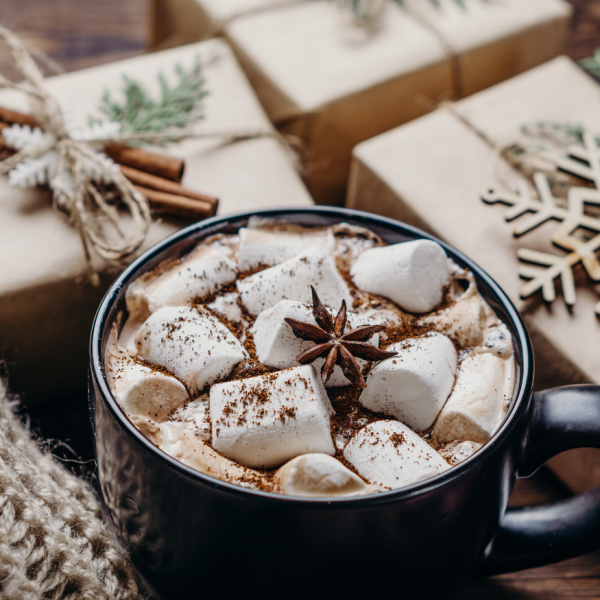 ot chocolate and marshmallows with small brown paper packages