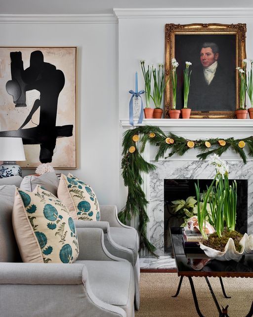 classic white living room with antique painting above fireplace
