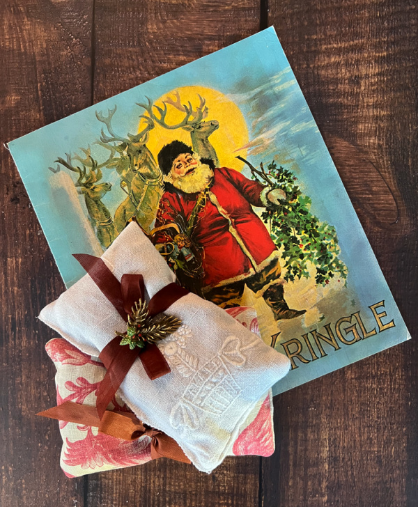 Monday Musings antique brooch on lavender sachet with a vintage Kris Kringle book