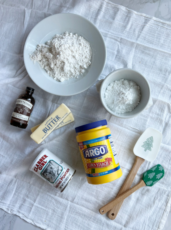 Ingredients for Viennese Whirl Cookies, including flour, vanilla extract, corn starch, baking powder and butter. 