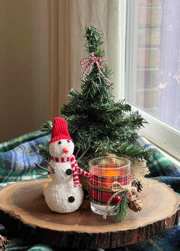 still life with snowman tree and candle