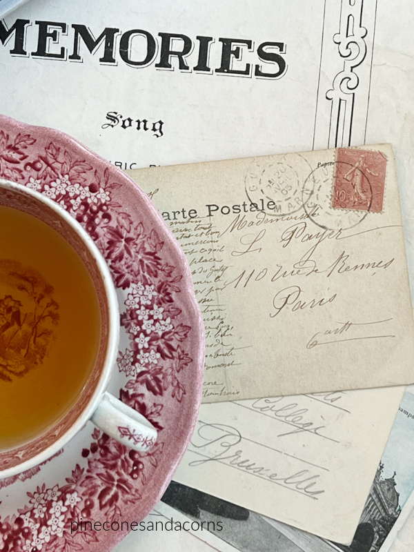 flatlay red transferware vintage postcards and Memories sheet music